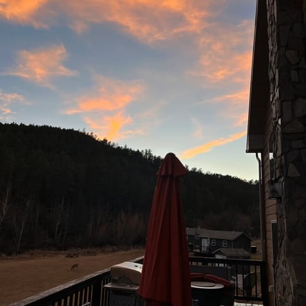 Family enjoying an evening fire pit near a Black Hills cabin